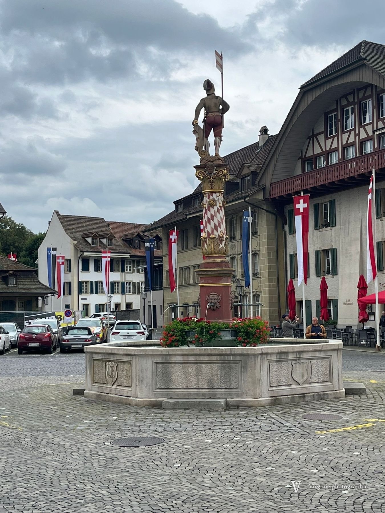 Une fontaine surmontée d’une statue sur la place de la vieille ville